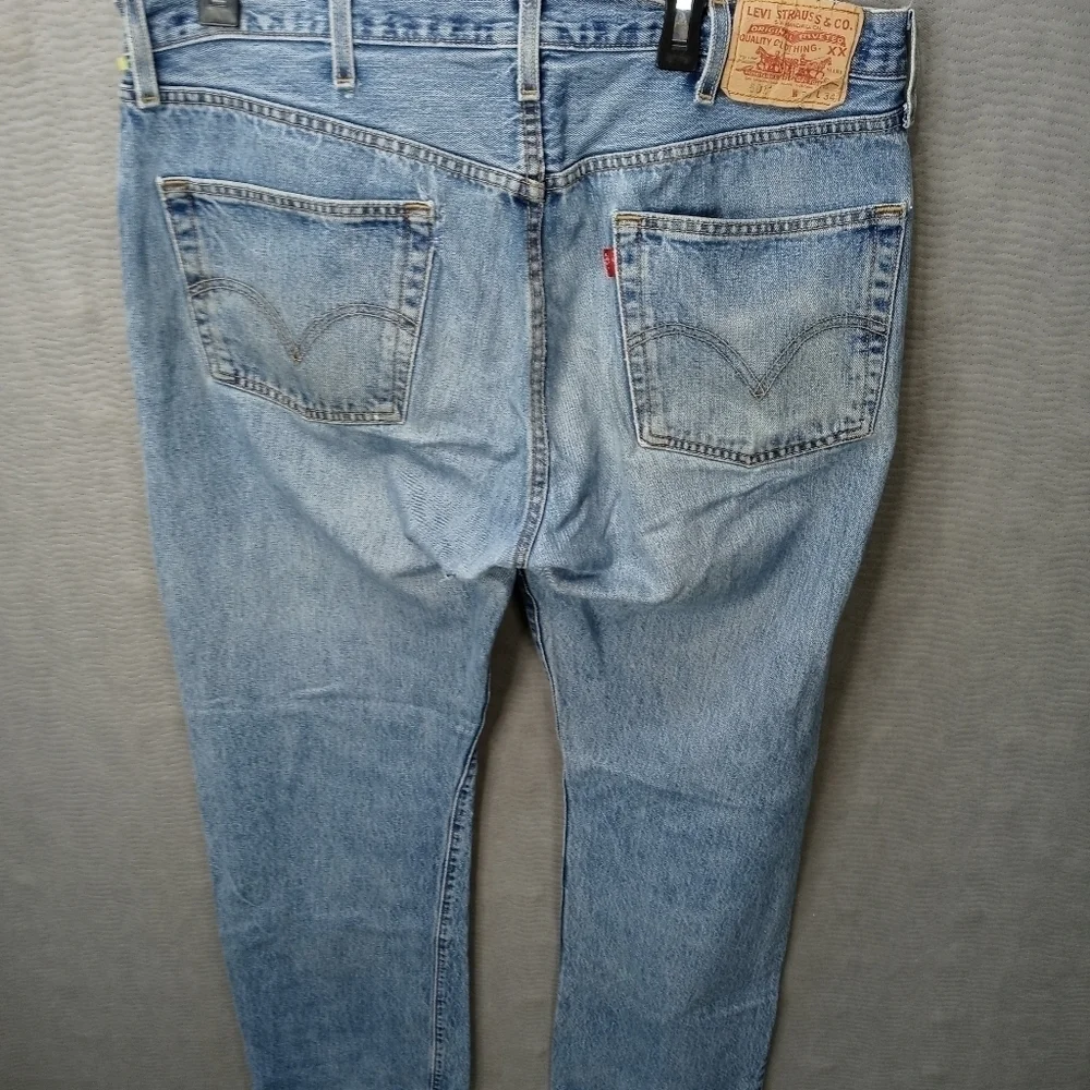 Levis 501XX men's button fly blue jeans. Sz 38x34.tear in seat. See last pic. M2